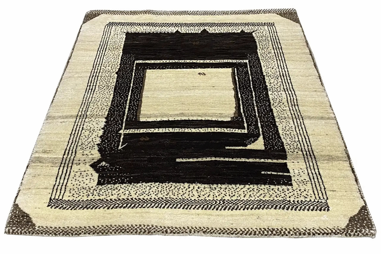 Gabbeh rug with a deep rectangular pattern in cream and dark brown, viewed from above.