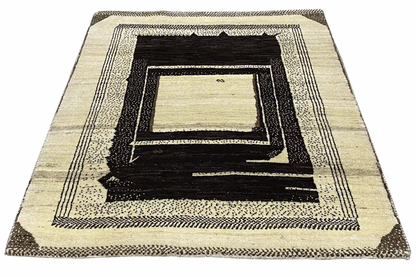 Gabbeh rug with a deep rectangular pattern in cream and dark brown, viewed from above.