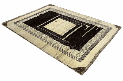 Gabbeh rug with a diagonal zoned pattern and short fringe border in cream and black.