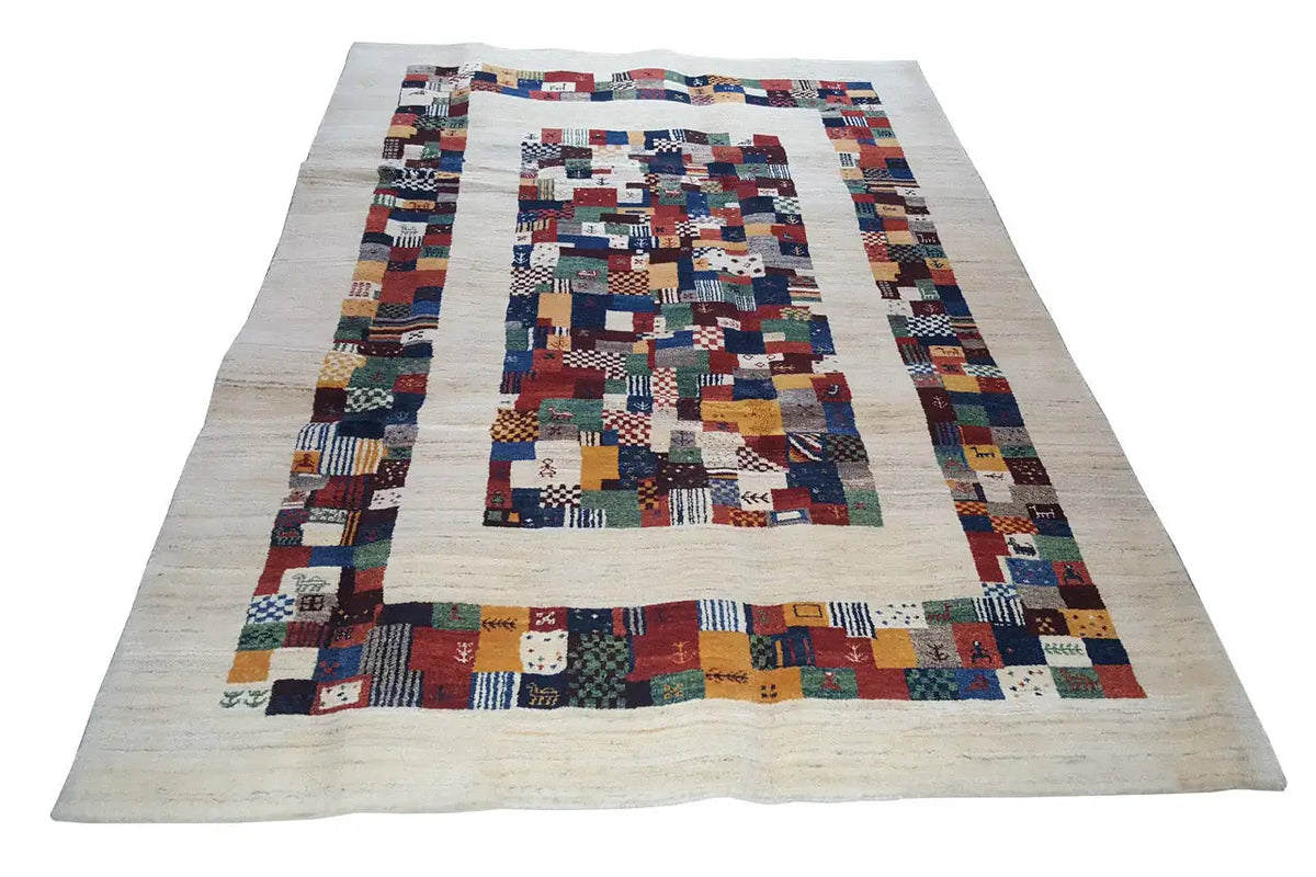 Gabbeh-style rug, patchwork-like with geometric color blocks on a light background