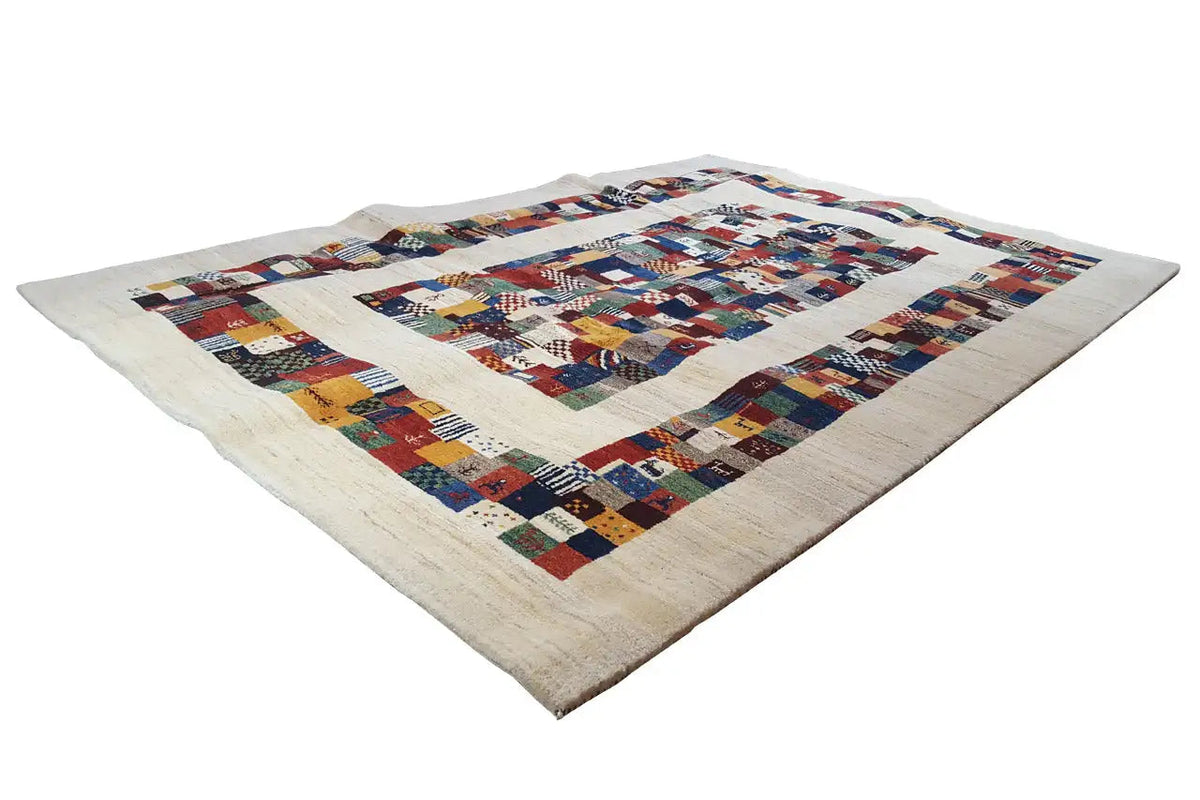 Gabbeh rug with a patchwork border and multicolored squares on a light backing fabric