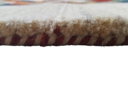 Rug edge with dense pile and short fringes, light fibers with reddish-brown accents