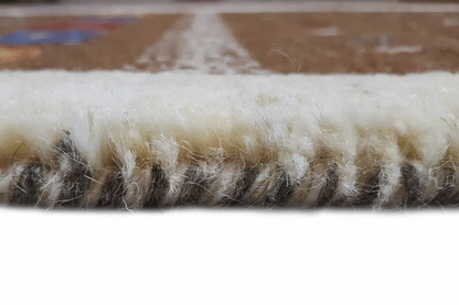 Gabbeh rug, side view of the pile: dense brown wool felt with a light-colored edge