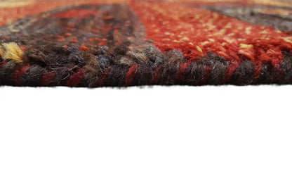 Close-up of the edge of a Gabbeh rug: dense, dark pile