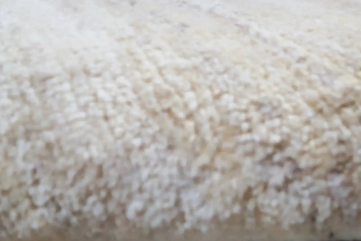 Gabbeh rug detail, light beige texture with a dense pile appearance