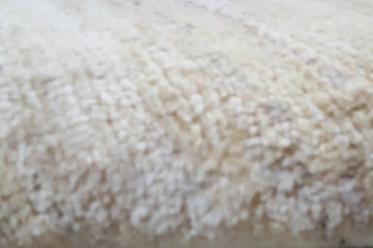 Gabbeh rug detail, light beige texture with a dense pile appearance