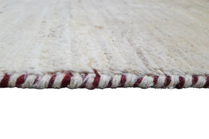 Gabbeh rug fringe detail, light wool with red threads along the edge