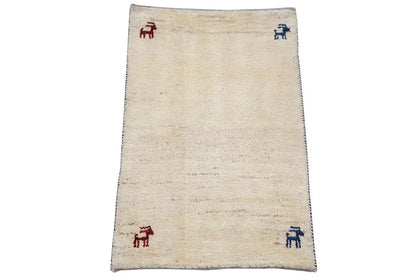 Gabbeh rug 86x56 cm, rectangular, beige background with four animal motifs in red/blue