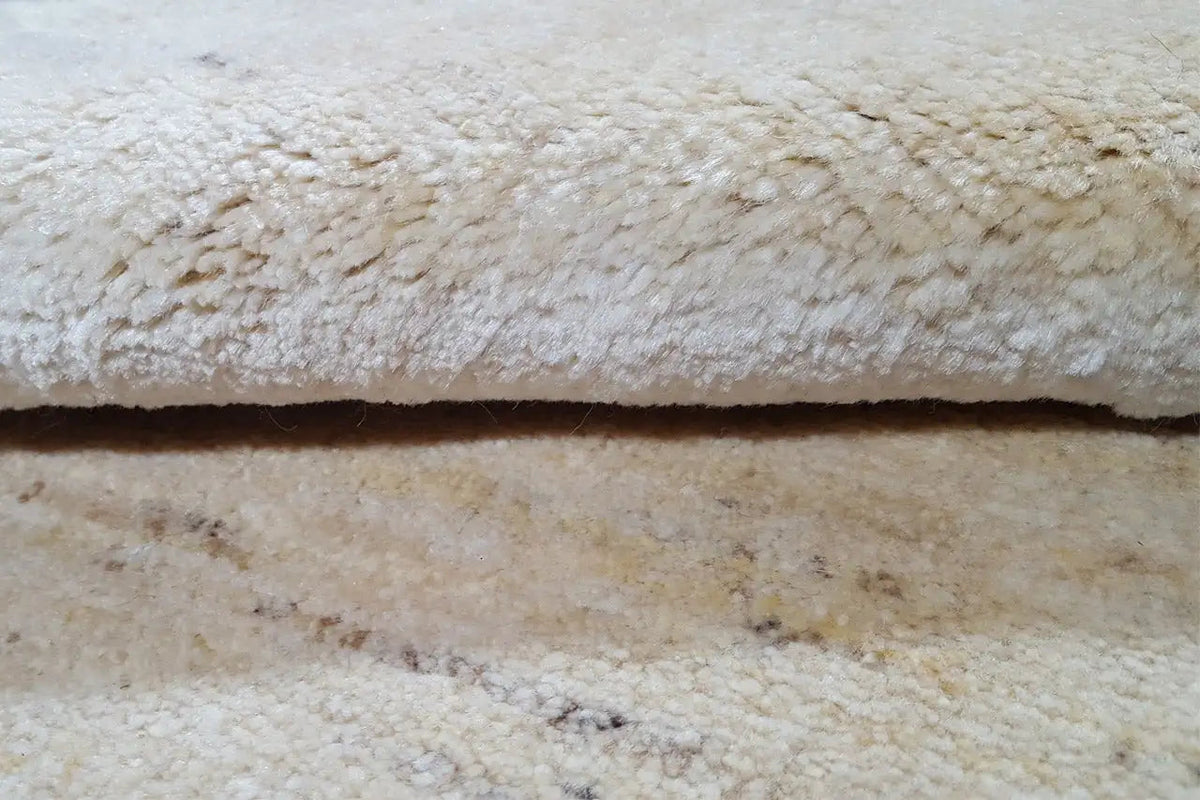 Gabbeh rug 86x56 cm, close-up of the beige pile with a fine woven texture