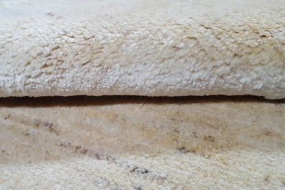 Gabbeh rug 86x56 cm, close-up of the beige pile with a fine woven texture