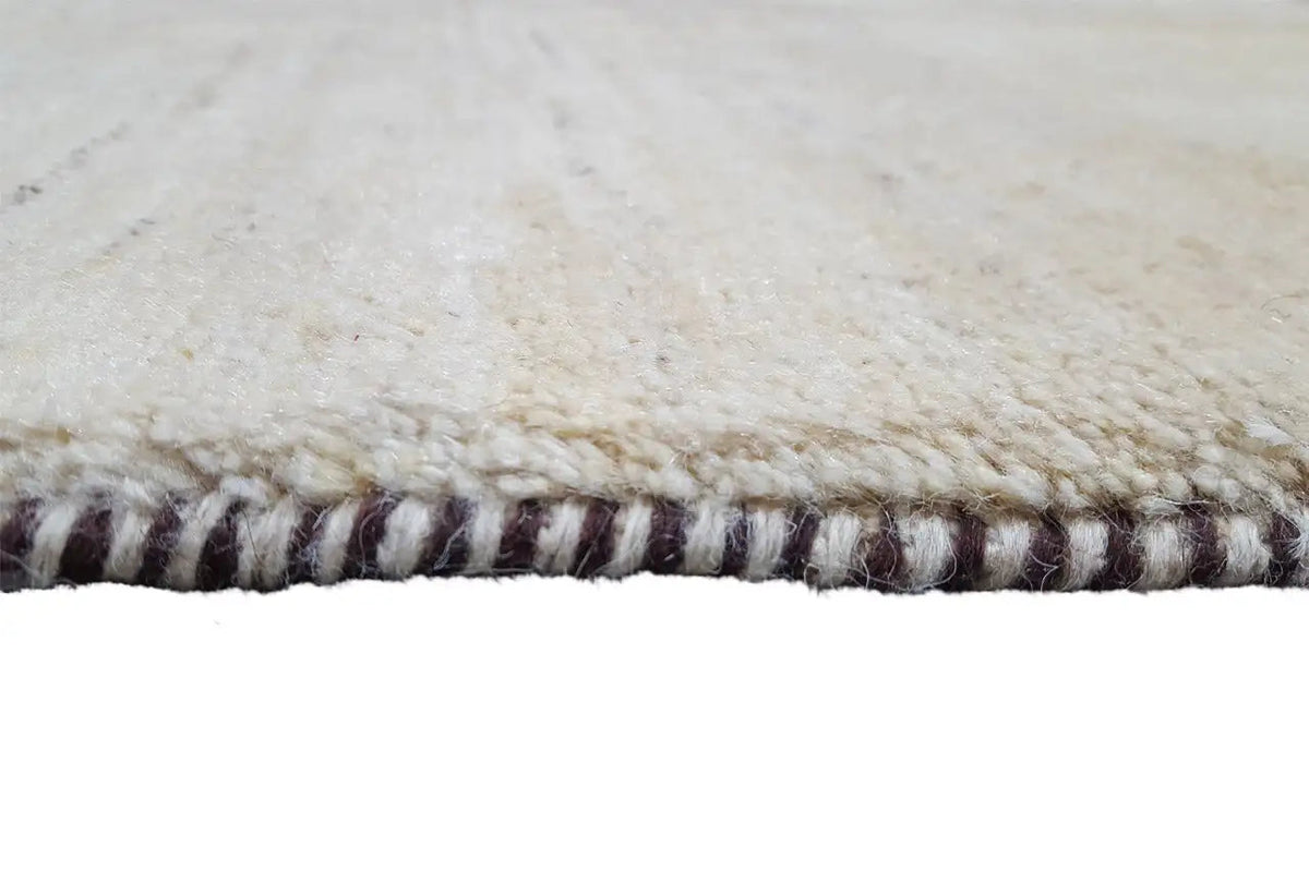 Gabbeh rug 86x56 cm, detail of the bound edge with a multicolored twisted-yarn fringe finish