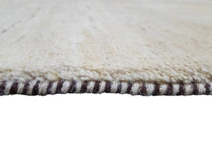 Gabbeh rug 86x56 cm, detail of the bound edge with a multicolored twisted-yarn fringe finish
