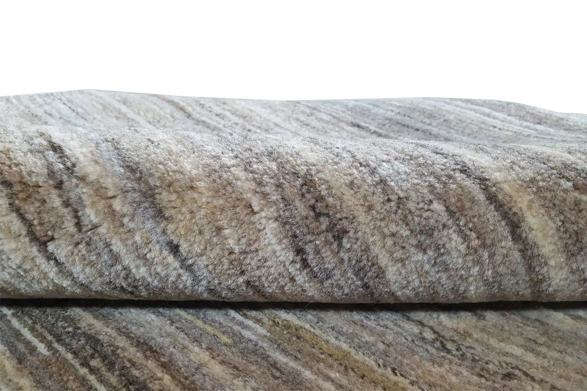 Natural gabbeh rug: close-up of the texture with mottled gray and beige tones
