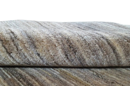Natural gabbeh rug: close-up of the texture with mottled gray and beige tones