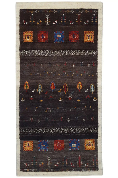 Gabbeh rug with a dark pattern and colorful squares, with a light-bordered edge (135x66 cm).