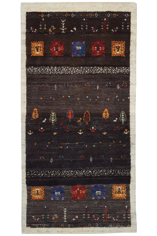 Gabbeh rug with a dark pattern and colorful squares, with a light-bordered edge (135x66 cm).