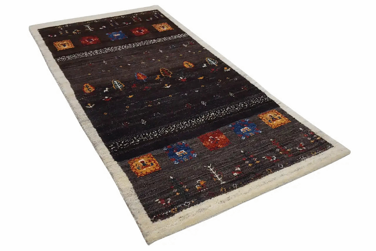 Gabbeh rug with a dark floral/ornamental pattern, colorful squares, and a light border (135x66).