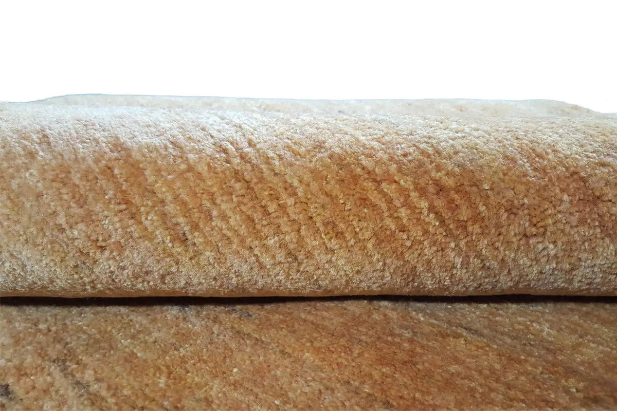 Gabbeh rug in gold, close-up of the pile and edge, brown-gold texture