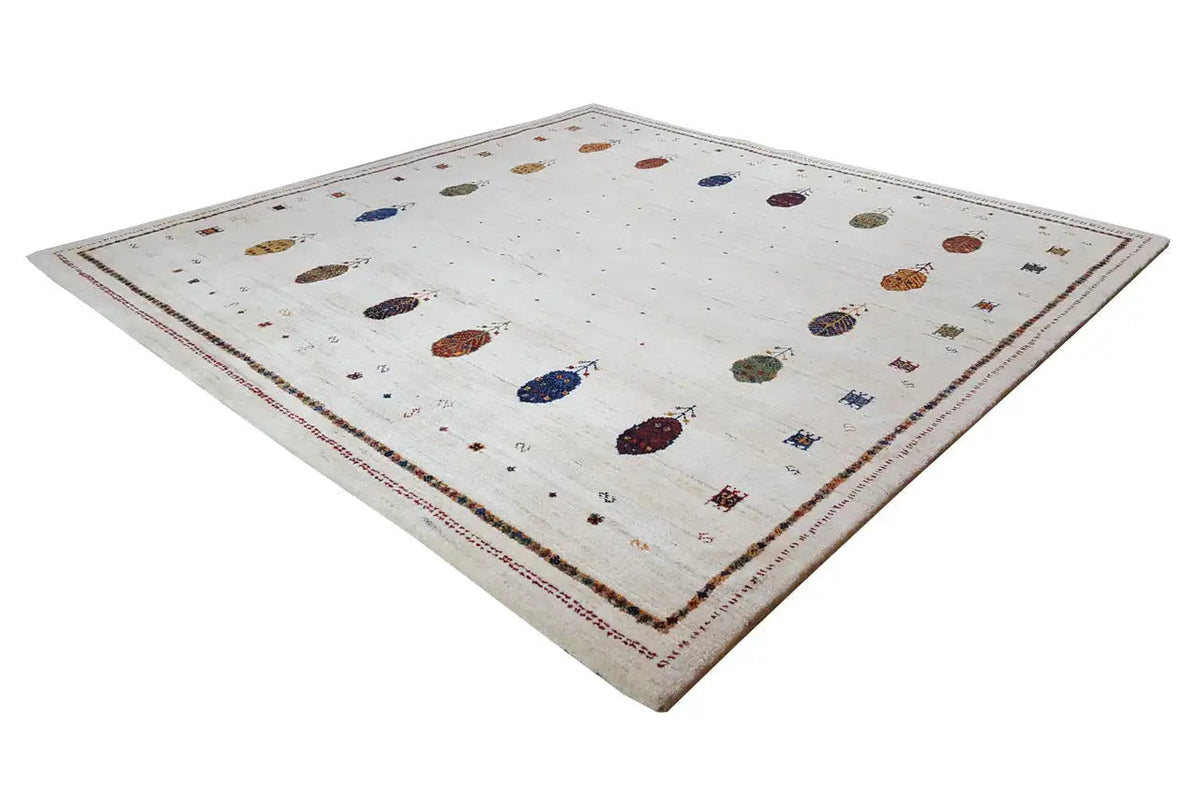 Gabbeh rug with a light background, scattered colorful ovals, and a surrounding border