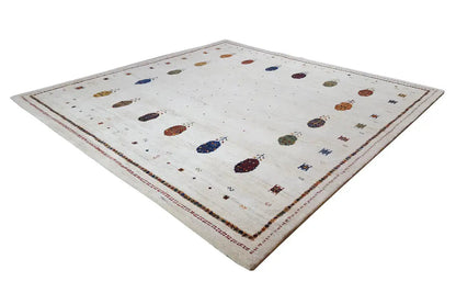 Gabbeh rug with a light background, scattered colorful ovals, and a surrounding border