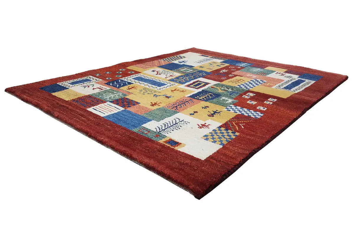 Gabbeh Luri rug with yellow, blue, and red ornamental panels in a patchwork design