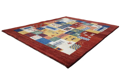 Gabbeh Luri rug with yellow, blue, and red ornamental panels in a patchwork design