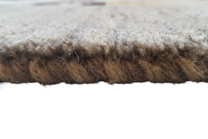 Carpet edge in detail: dense, slightly plush pile in light beige with brown tones