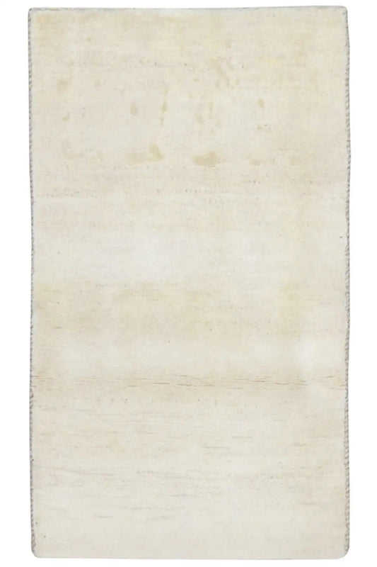 Rectangular beige rug with subtle, irregular color patches