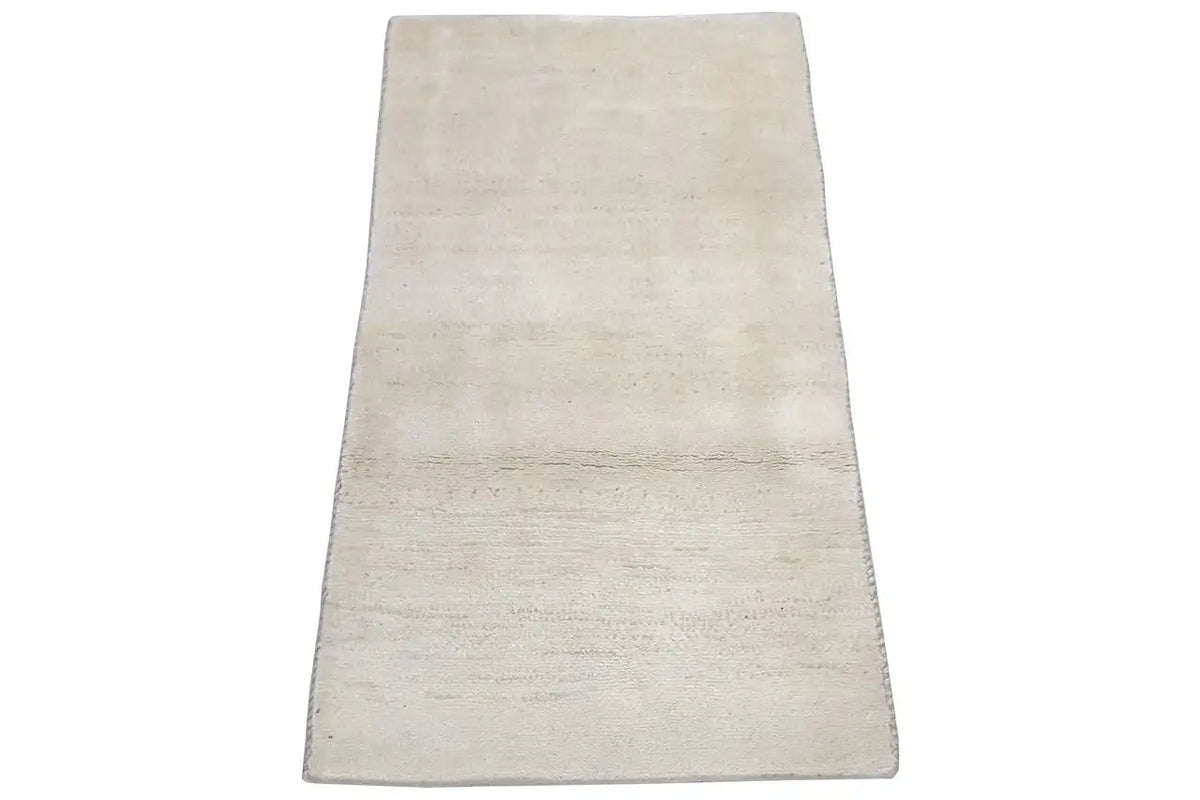 Beige rectangular rug in a slightly narrow perspective, with no visible pattern