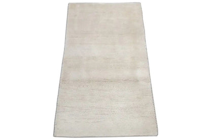 Beige rectangular rug in a slightly narrow perspective, with no visible pattern