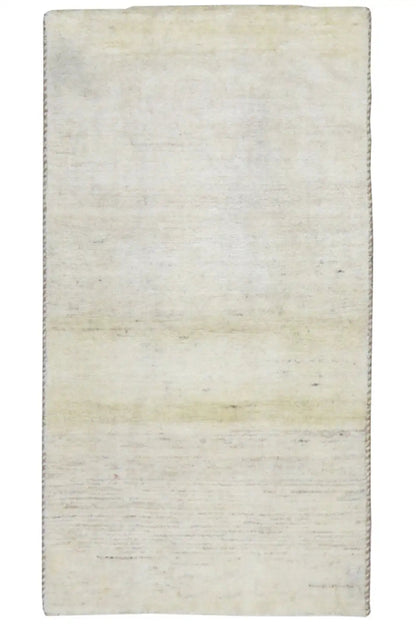 Beige Gabbeh rug, rectangular, with a simple mottled surface.