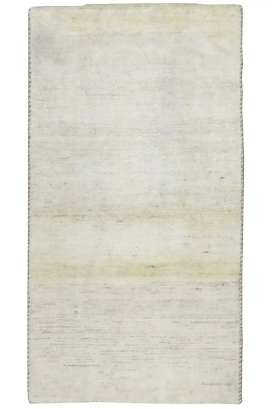 Beige Gabbeh rug, rectangular, with a simple mottled surface.