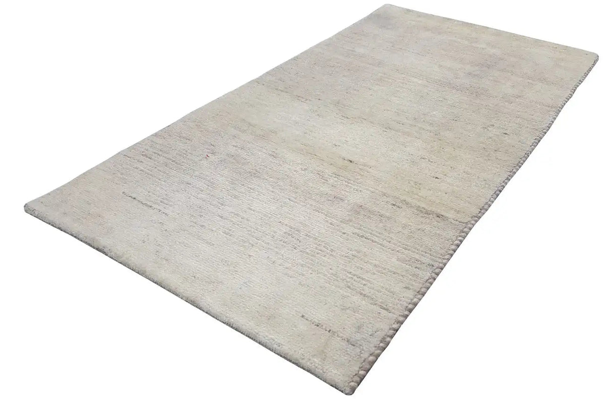 Light Gabbeh rug, rectangular, mottled surface with fine streaks.