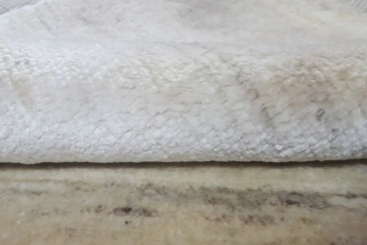 Close-up: carpet edge with loop pile and dark underside.