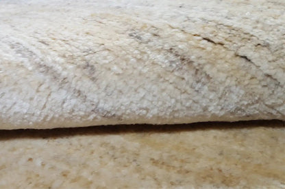 Gabbeh rug, detail view: beige pile with an irregular texture