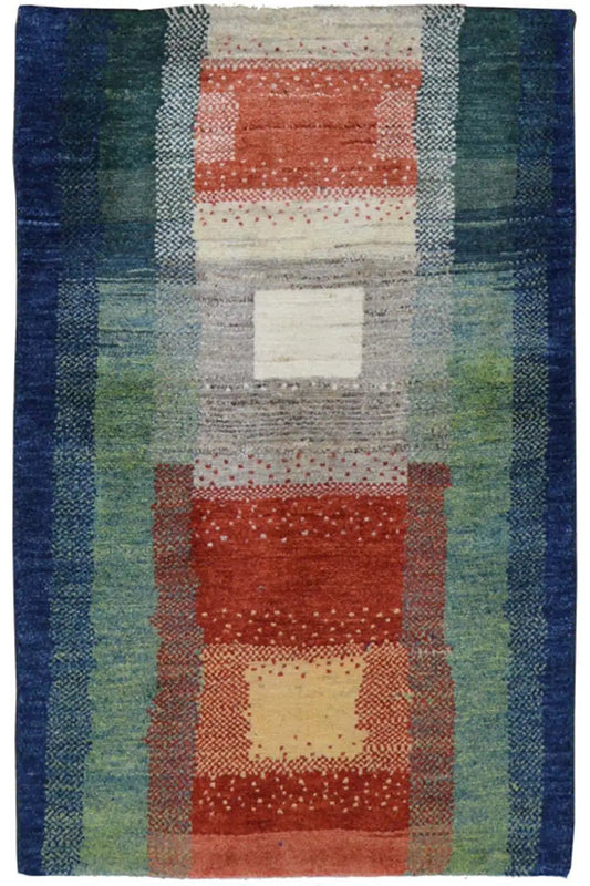 Gabbeh rug with geometric patchwork in blue, green, red, and cream