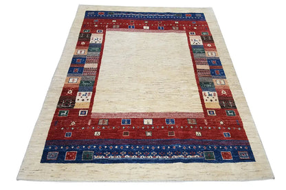 Gabbeh rug, cream-colored field with a red border and blue patterned stripe