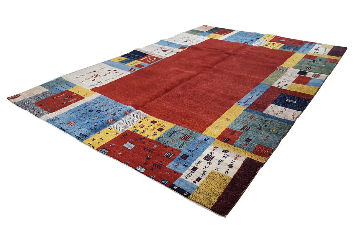 Gabbeh rug in a patchwork look with a red square and blue-yellow border panels