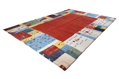 Gabbeh rug with a red center, surrounded by multicolored patterned squares