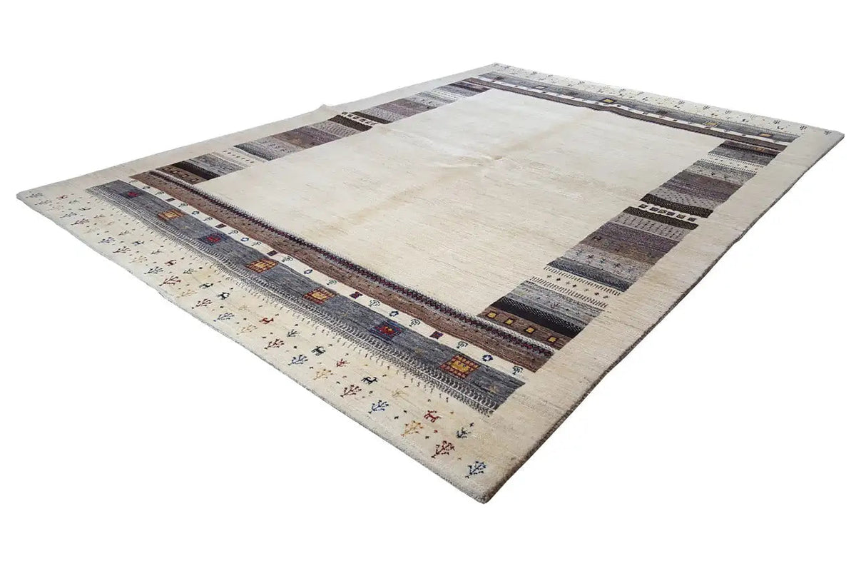 Rectangular Gabbeh rug with a light central area and dark patterned borders