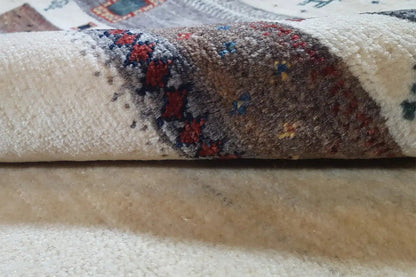 Close-up: carpet edge with patterned strips and multicolored accents in the pile