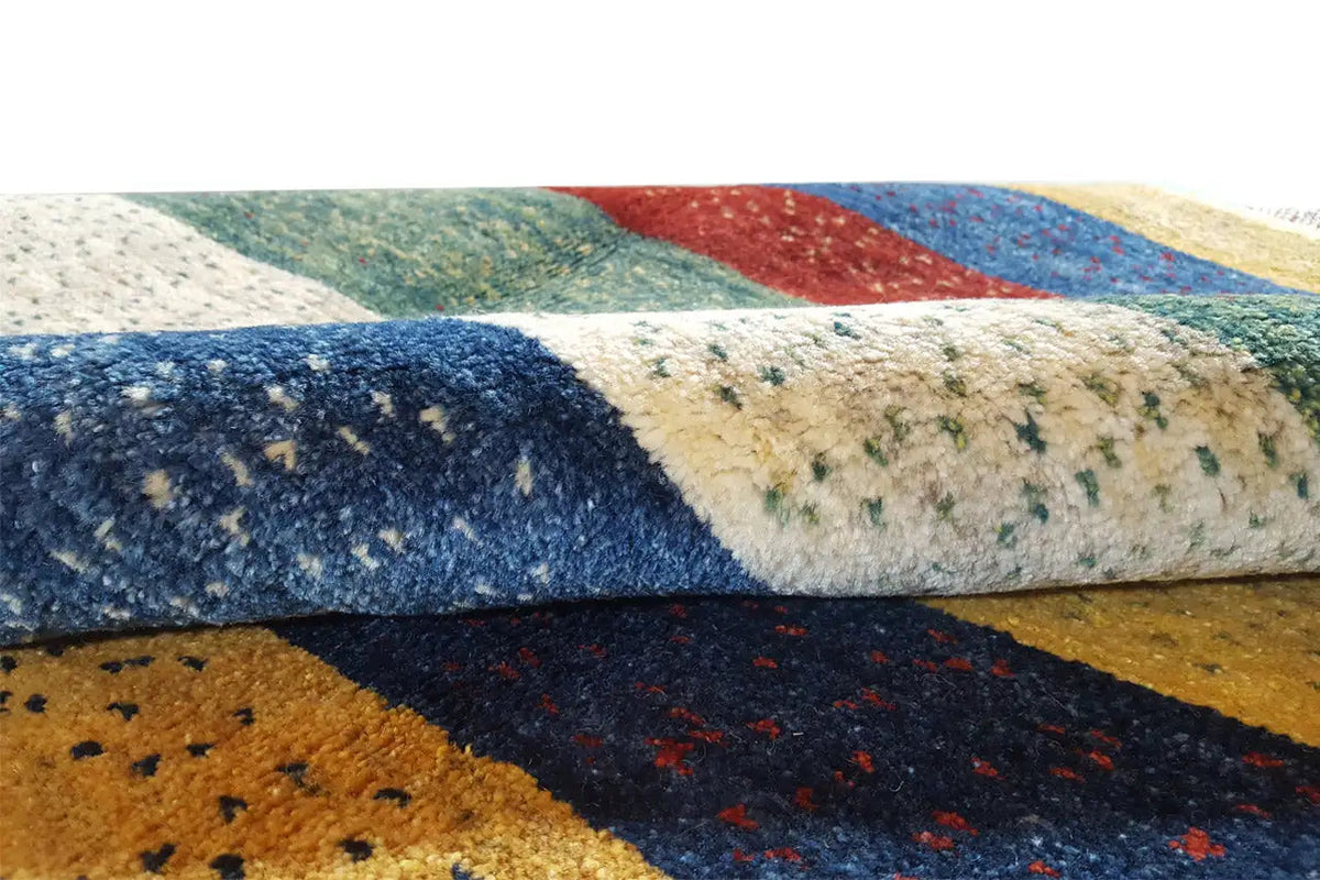 Close-up of the Gabbeh rug: braided pile texture and colored stripes