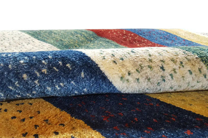 Close-up of the Gabbeh rug: braided pile texture and colored stripes