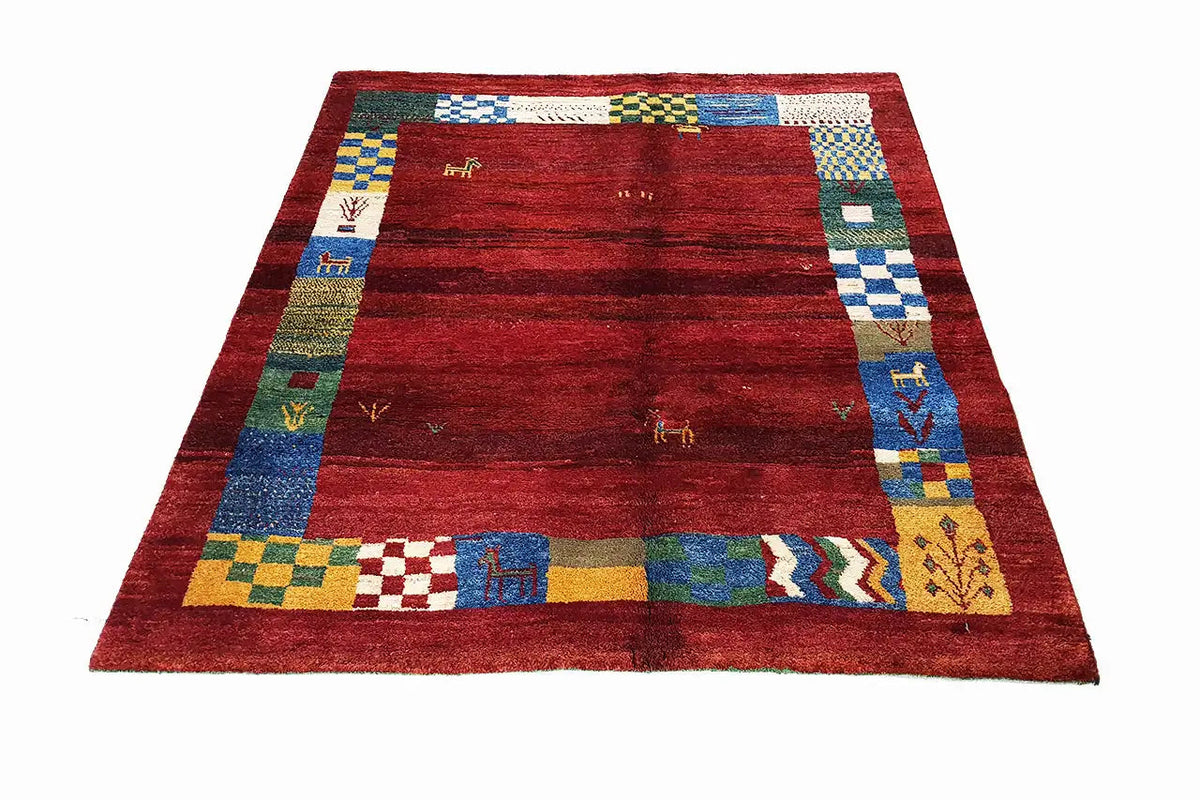 Gabbeh rug (176×145 cm) with a central red field and a colorful border with diamonds