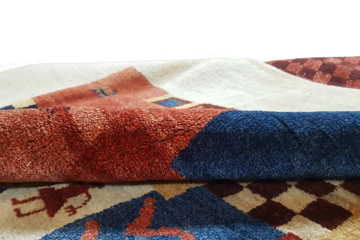 Gabbeh-Lori rug detail: woven areas of red and blue with a textile texture