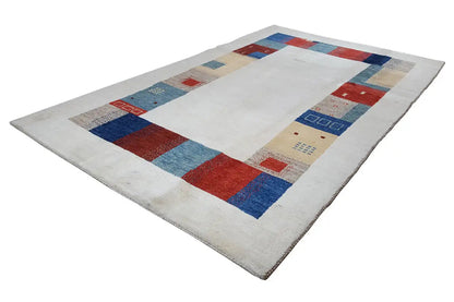 Gabbeh rug viewed from above with a border of squares and color fields all around