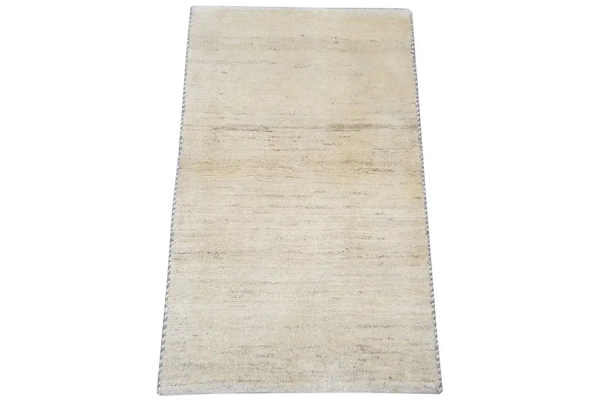 Gabbeh rug 60x53 cm, side view with beige pile and fringes along the edge