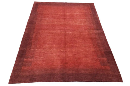 Reddish-brown carpet, broadly laid out with a mottled look and a dark border area