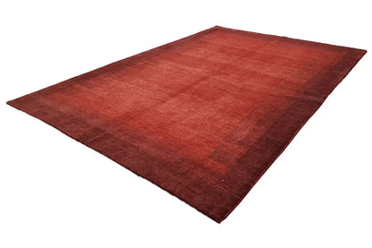 Reddish-brown rug spread diagonally with subtle, contrasting color blocks