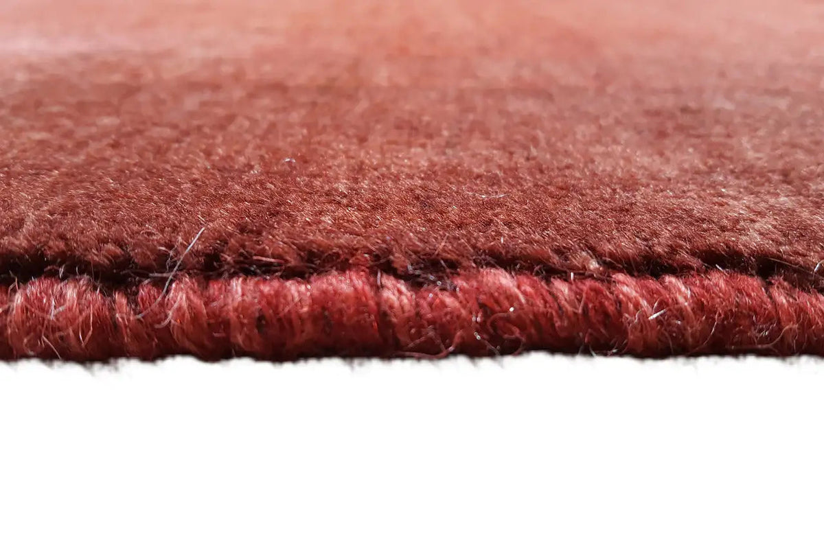 Close-up of a carpet edge with short, dense pile and a clean finish